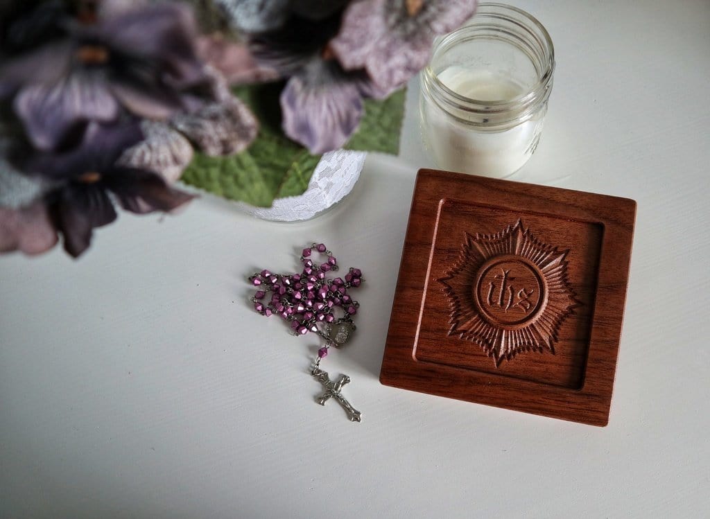 carved wooden spiritual communion prayer card with rosary and flowers